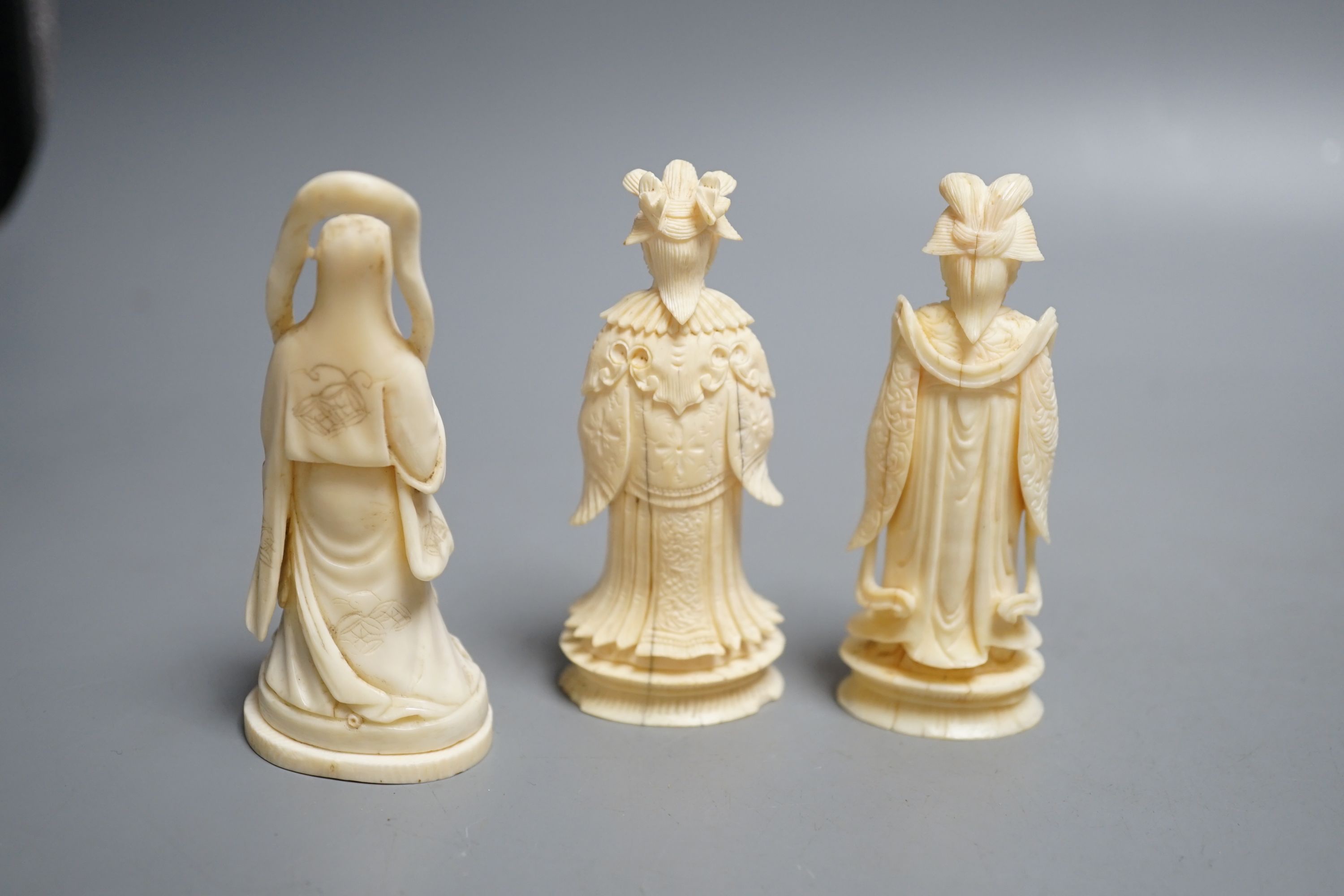 A Chinese ivory figure of Guanyin, a pair of ivory chess pieces, two Cantonese napkin rings and a Cantonese ivory plaque with flowers, 19th/early 20th century , tallest chess piece 8.5 cms high.